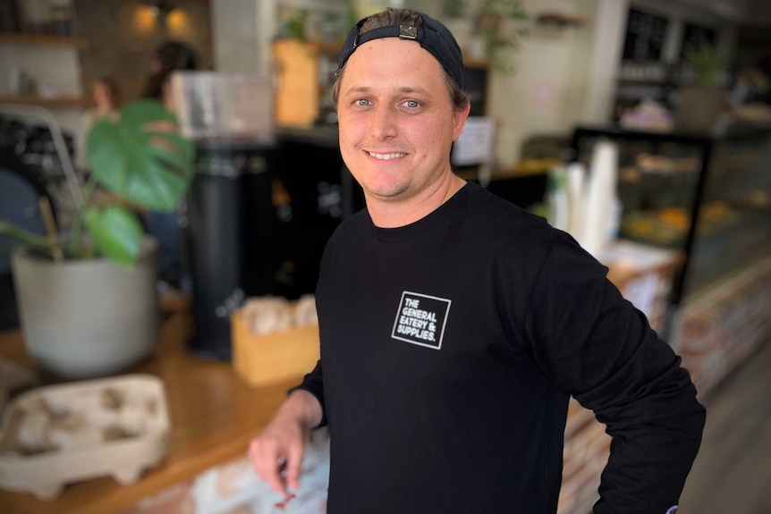 Dave Moran, co-owner of The General, a cafe in Dulwich Hill, stands in front of the counter.