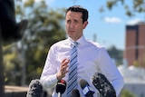 David Crisafulli speaking into microphones outside Ipswich Hospital.