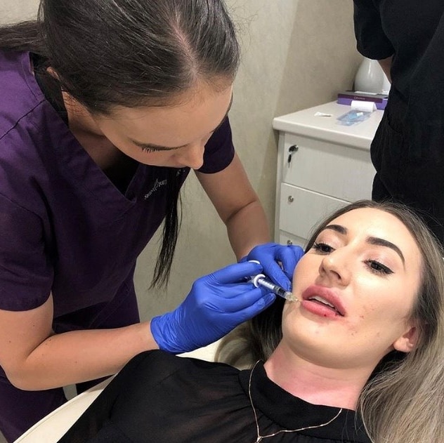 Woman receiving cosmetic injections