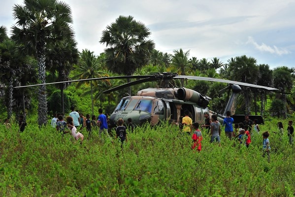 Children gather to get a closer look at an Australian Army Black Hawk helicopter in East Timor.