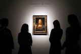 People gather around Leonardo Da Vinci's Salvator Mundi