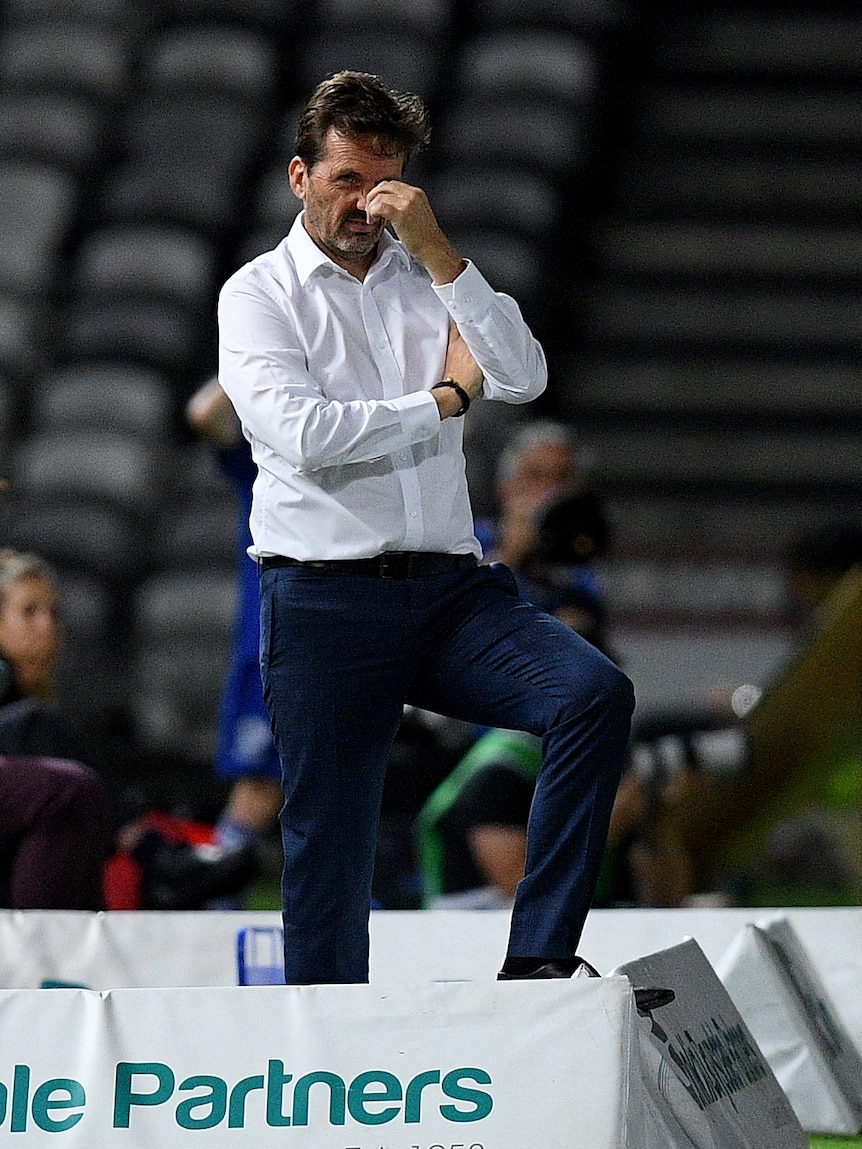 Central Coast Mariners coach Mike Mulvey grimaces while coaching an A-League game.