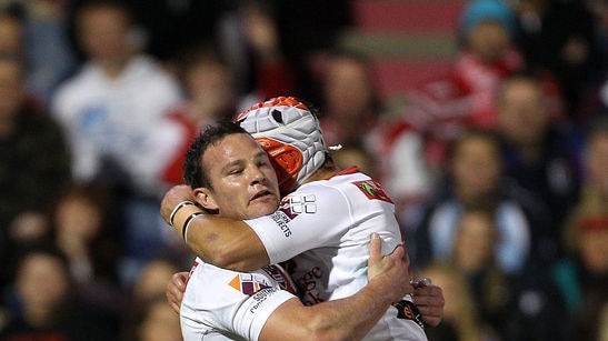 Top of the world...Jamie Soward celebrates with team-mate Dean Young after another Dragons try.