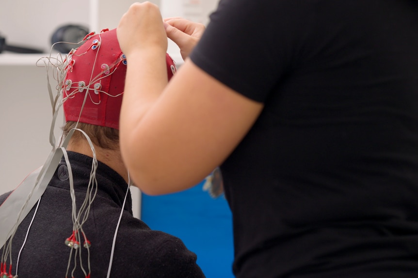 A boy is hooked up to a brain electrode monitor