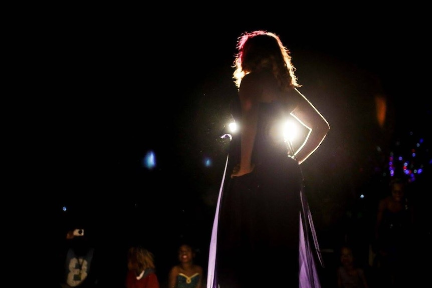 A photo of a female model in the Kiwirrkurra Fashion Show