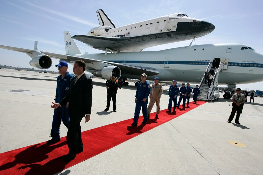 Endeavour crew members walk on the tarmac at LAX.