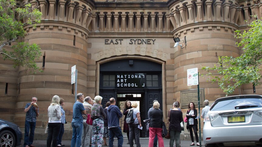 Tour groups stands outside the National Art School Forbes St entrance in Darlinghurst