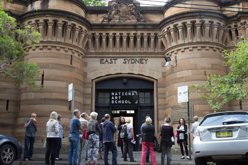 Tour groups stands outside the National Art School Forbes St entrance in Darlinghurst