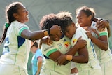 Four Fijiana Drua players celebrate a try in the Super W final against NSW Waratahs.