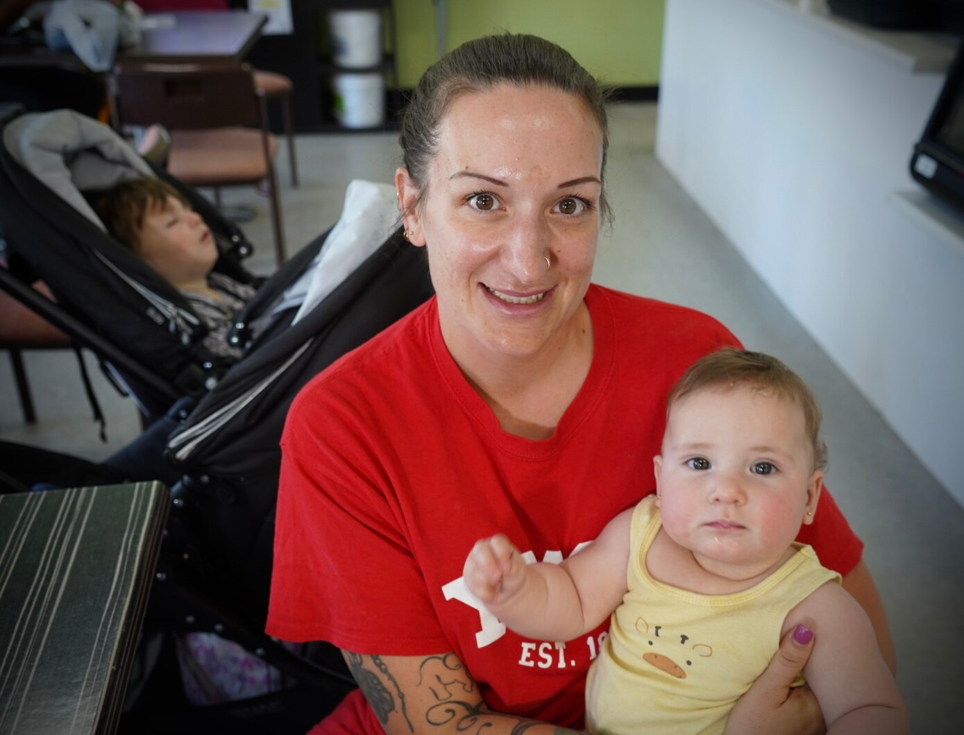 A woman holds a child.