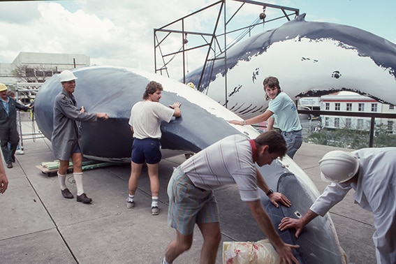 People putting the whale piece together.