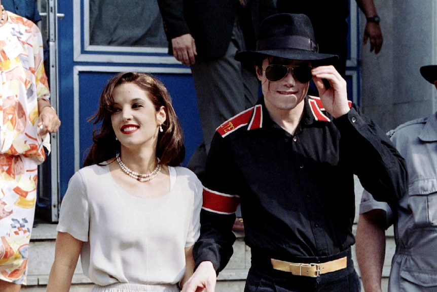 Lisa Marie holding hands and walking with Michael Jackson. 