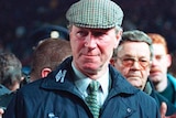 Jack Charlton looks dapper in his hat and coat while police and fans surround him