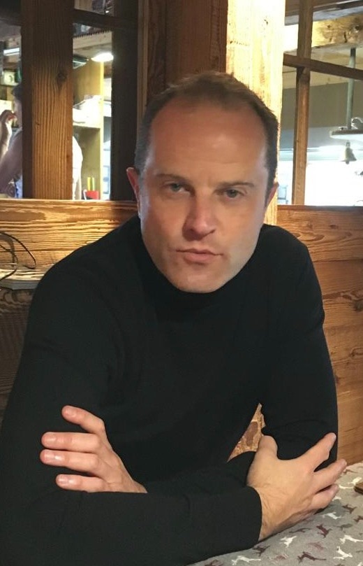 Portrait of a man in black shirt.