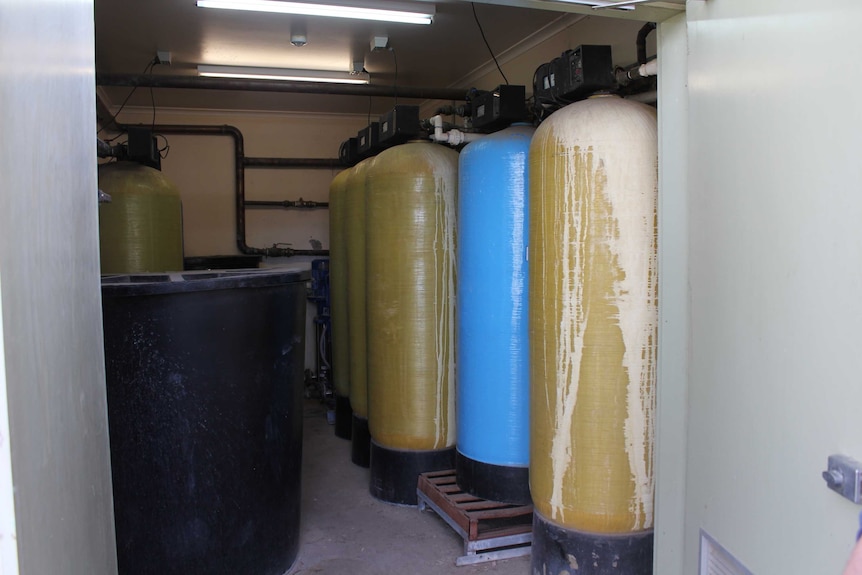 Tall and thin tanks used to treat water for dialysis treatment