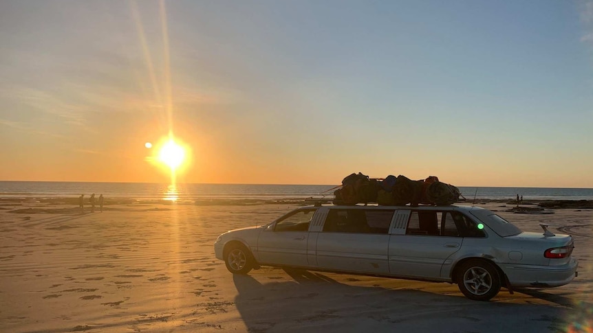 A limousine is parked on Broome's Cable Beach at sunset.