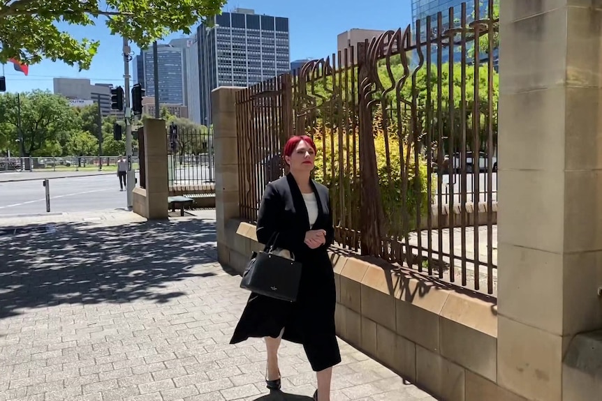 A woman walks outside a court building