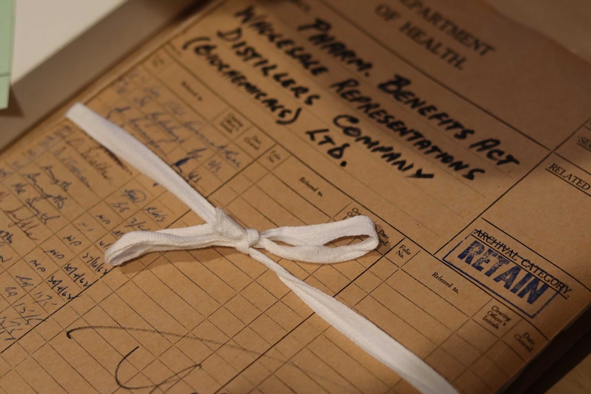 A pile of documents held together with a fabric bow.