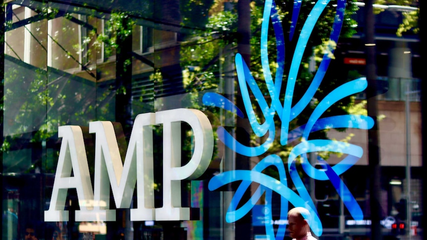 AMP logo in the window of the wealth manager and bank's Sydney CBD branch, with people reflected in glass.