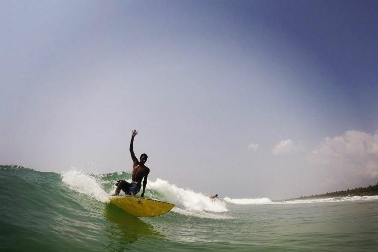Alphonse Coulibaly surfing a wave