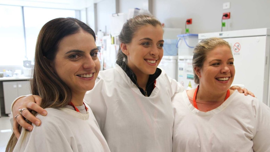 Three young ladies in a scientific lab