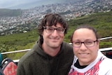 Stathi Paxinos and his wife Jo take a selfie. A city and the ocean is in the background.