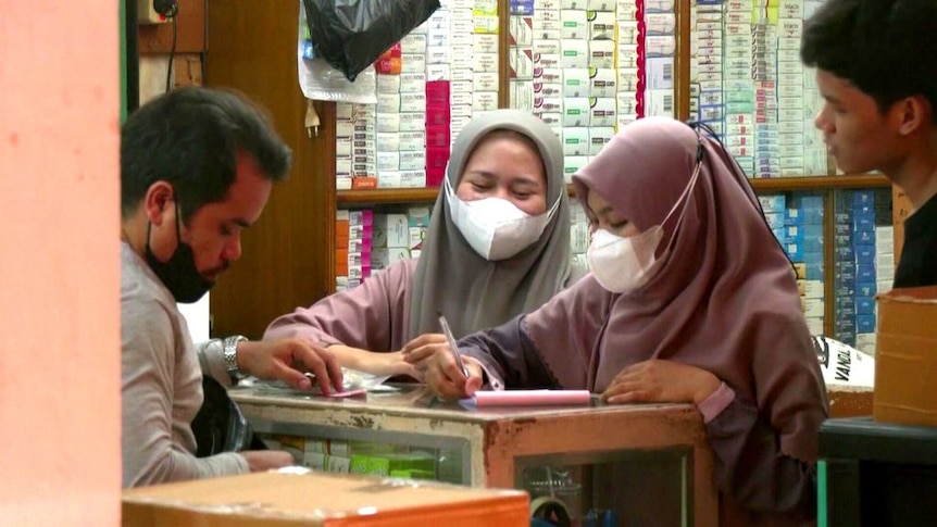 Indonesian women at a pharmacy. 