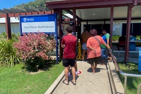 People lining up in front of a health service for a Covid-19 test