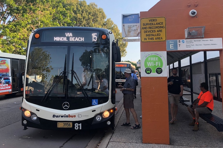 A bus heading to Mindil Beach with a man about to step on