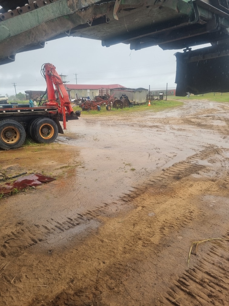 Puddles of mud gather in machinery shed next to a house in Innisfail.