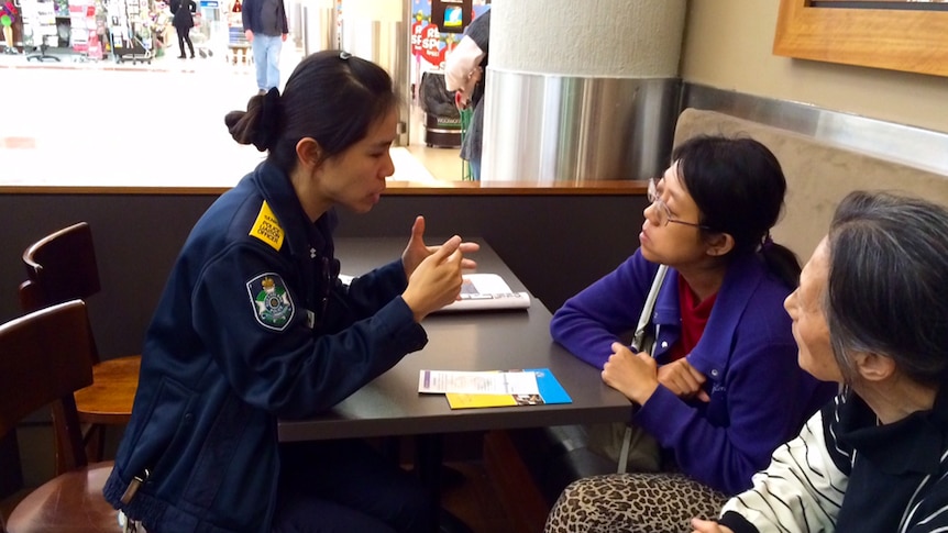 One of the police liaison officers sits down with local residents to pass on information about local police services.