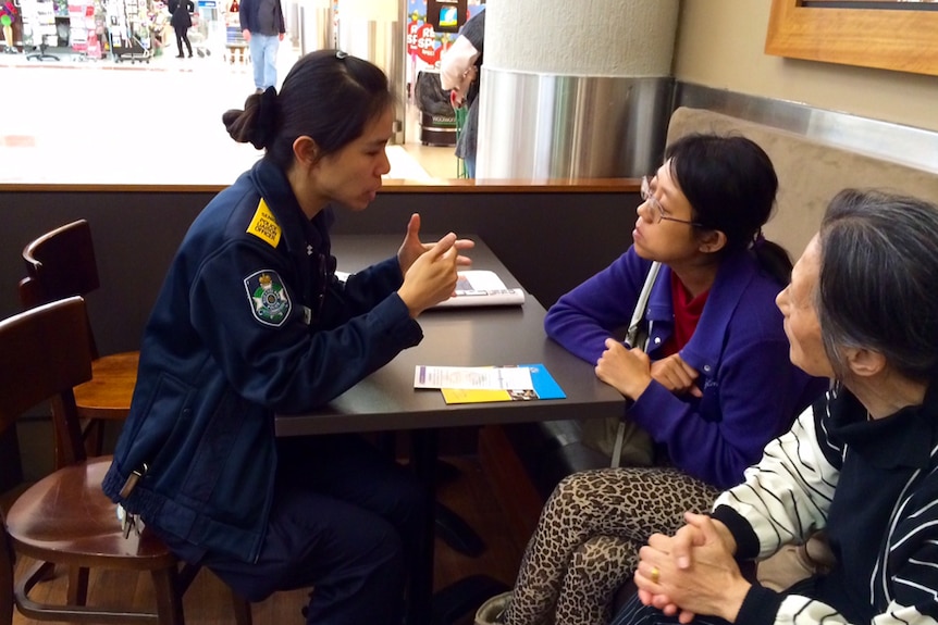 One of the police liaison officers sits down with local residents to pass on information about local police services.