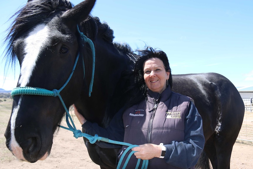 Karen smiles, holding Diesel around the neck.