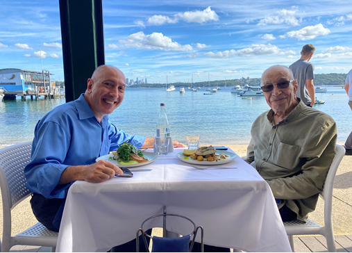 Andrew Larcos with his dad at a restaurant by the water