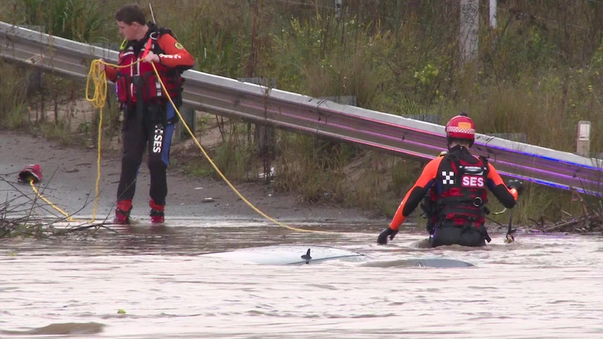Two SES team members in flood waters