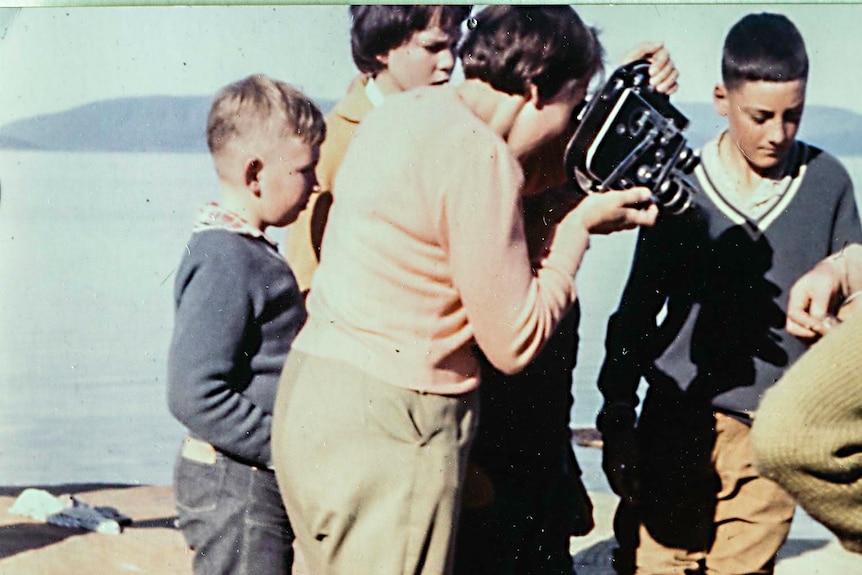 A woman filming with a handheld camera