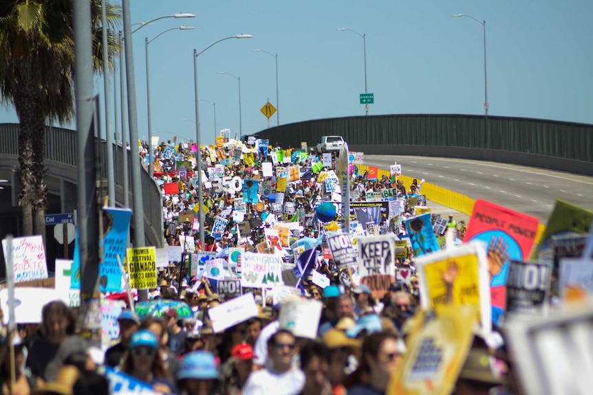 A lane of the highway in los angeles is packed with protesters