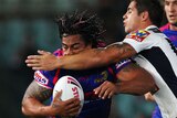Rough and tumble: Fuifuio Moimoi cops some heavy treatment from the Broncos' defence.