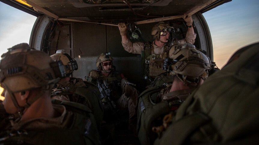Military personnel in a military aircraft.