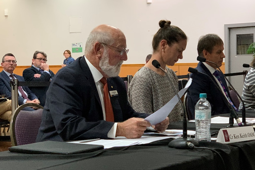 Man and woman sitting at a table in front of public gallery