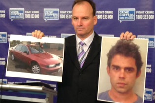 A photo of Michael Pruiti and his car held by detective senior sergeant James Bradley