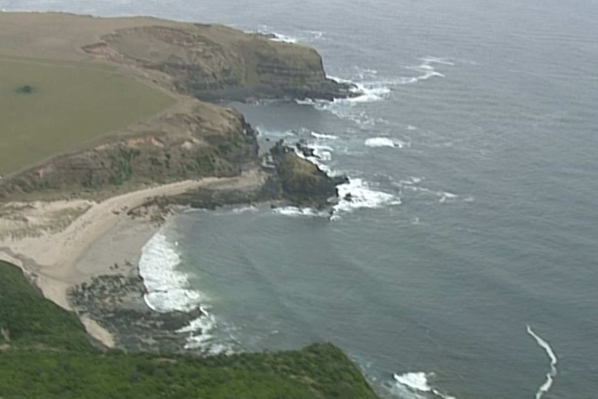 A rocky stretch of coastline, viewed from a helicopter.