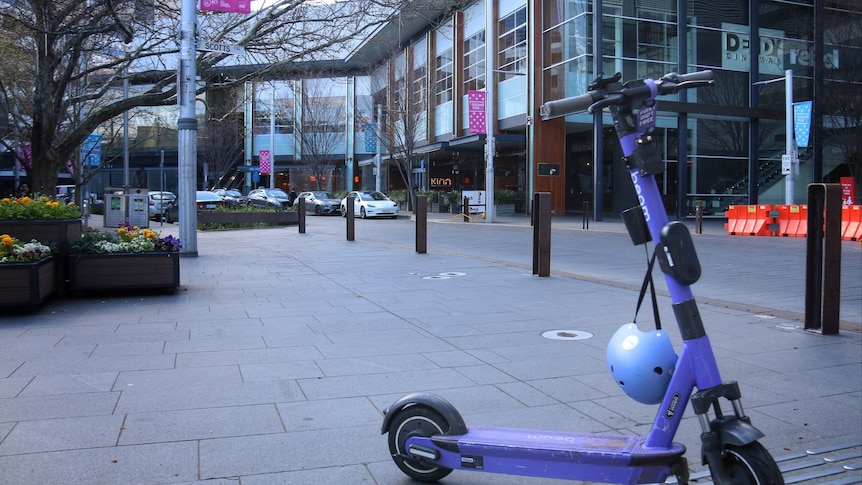 An electric scooter stands with nobody in sight.