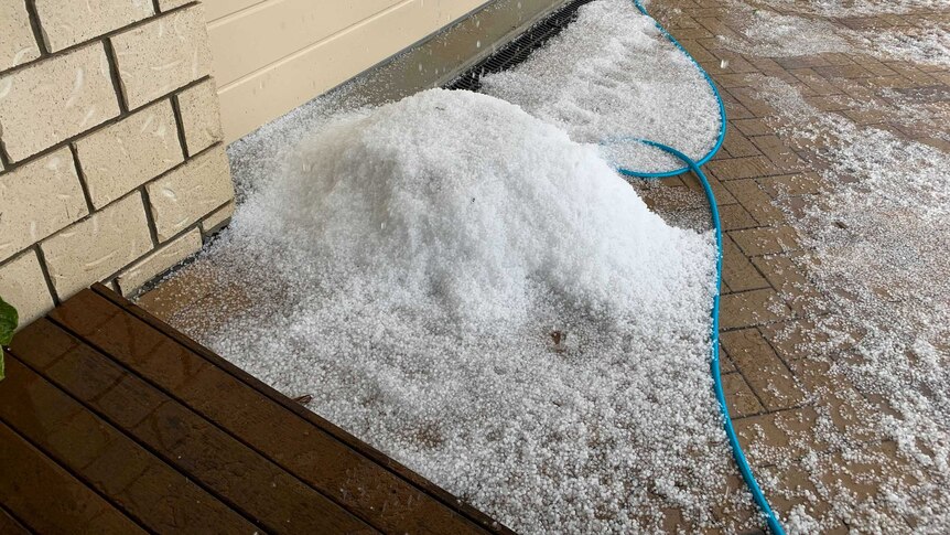 A pile of hail near the garage door of a home in Heathwood.