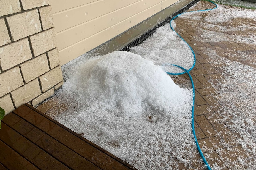 A pile of hail near the garage door of a home in Heathwood.