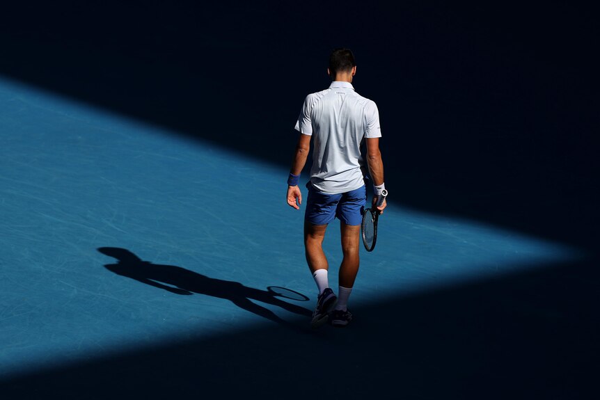 Novak Djokovic walks on court during his Australian Open semifinal