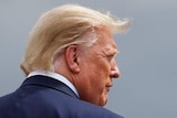 U.S. President Donald Trump walks on the tarmac as he arrives on campaign travel