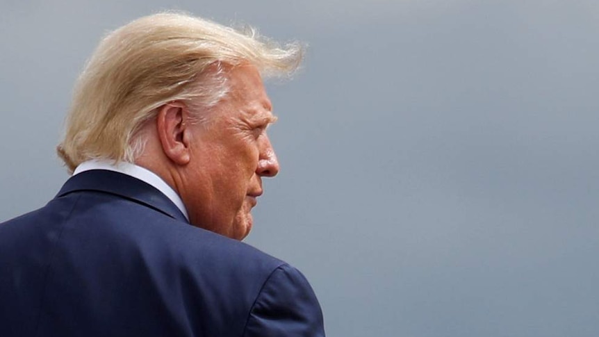 U.S. President Donald Trump walks on the tarmac as he arrives on campaign travel