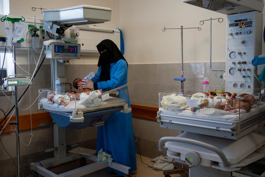 A nurse prepares premature babies for transport to Egypt after they were evacuated from Shifa Hospital in Gaza.