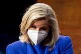 Liz Cheney chats with her arms crossed